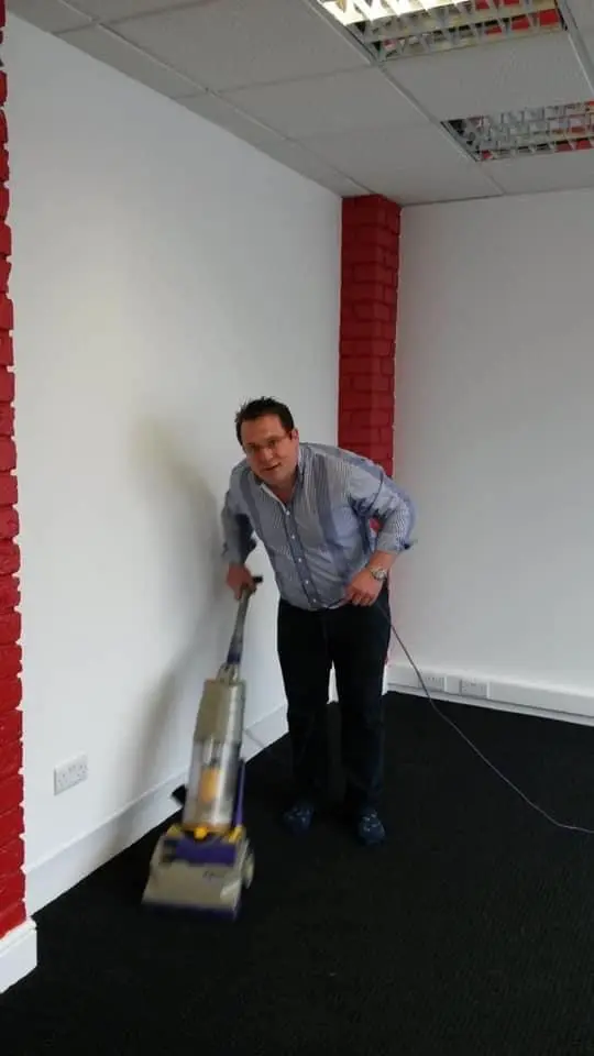 Dominic Murphy hoovering his first estate agency office